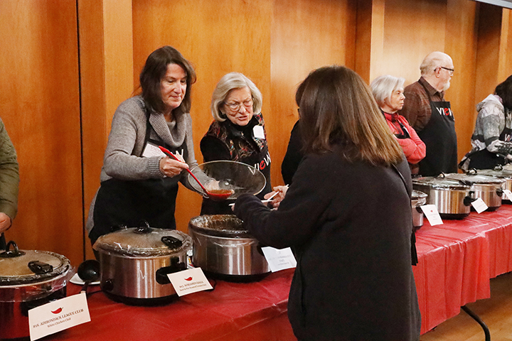 Volunteer Martha Allen scoops chili for a hungry attendee sm